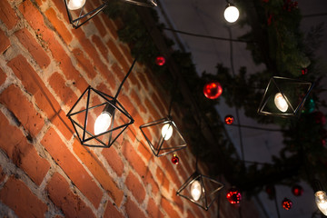 Brick wall with light bulbs in the New Year's style