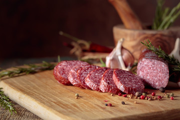 Smoked salami on a old wooden table.