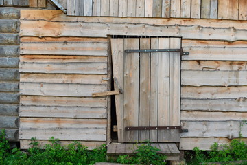 Door in the wall of a wooden log house