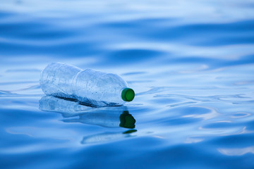 Plastic bottles on the river, plastic waste in the sea, garbage collection, environmental concept