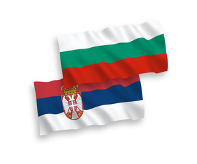 National vector fabric wave flags of Bulgaria and Serbia isolated on white background. 1 to 2 proportion.