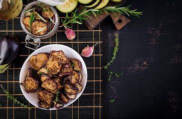 Italian sun-dried eggplant on a dark table. Preserved food. Italian appetizer. Top view