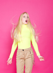 Portrait of fashion blonde surprised model girl young woman wearing stylish isolated on a pink