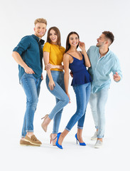 Group of young people in stylish casual clothes on white background