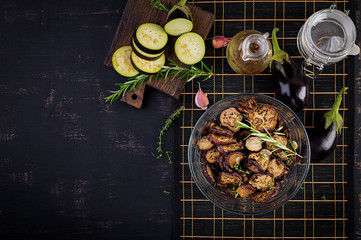 Italian sun-dried eggplant on a dark table. Preserved food. Italian appetizer. Top view
