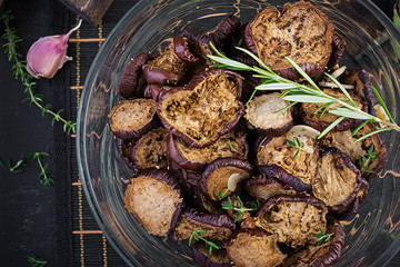 Italian sun-dried eggplant on a dark table. Preserved food. Italian appetizer. Top view