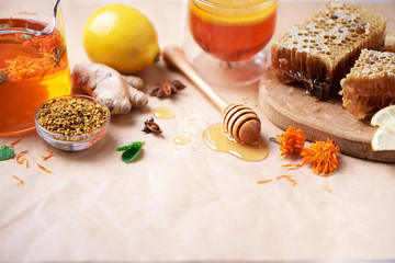 Ingredients for healthy hot drink. Lemon, ginger, mint, honey, apple and spices on craft paper background. Copy space. Alternative medicine concept. Clean eating, detox.
