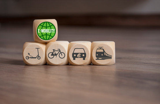 Cube and dice with green planet and e-mobility