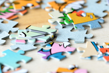 Colorful children puzzles on wooden background close-up