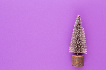 Christmas tree on pastel colored background. Christmas or New Year minimal concept.