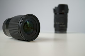 dslr camera lense, close-up view on table with smooth background