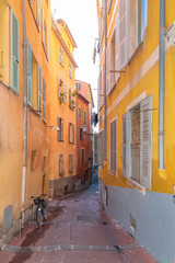 Fototapeta na wymiar Nice in France, small street with typical colorful facade in the old town