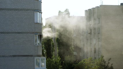 Clouds of grey smoke coming from the window of a burning apartment. 4K