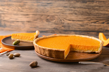 Tasty pumpkin pie on table