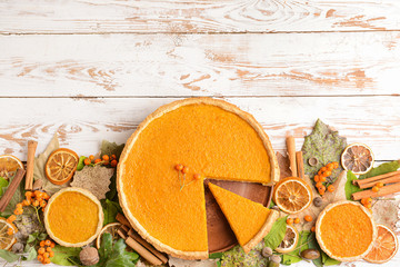 Composition with tasty pumpkin pie on wooden background