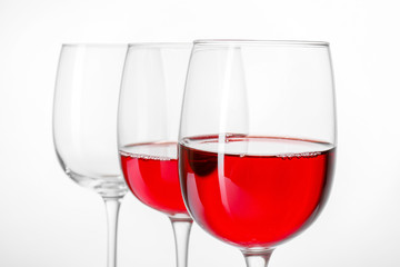 Glasses of wine on white background