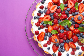 Tasty berry pie on color background