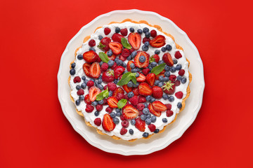 Tasty berry pie on color background