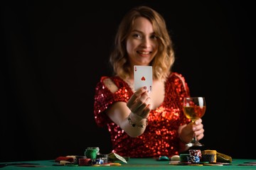 A girl plays in a casino. Focus on the cards, background for the gaming business