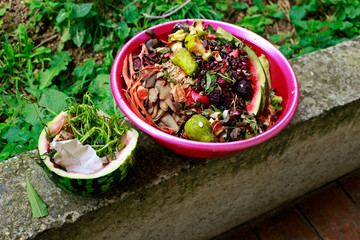 Kitchen waste thrown in composting bin for recycling and organic fertilizer. Homemade compost heap...