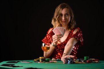 The girl plays in a casino in poker and in a night club. Game card, background for a casino. On a black background with space for design
