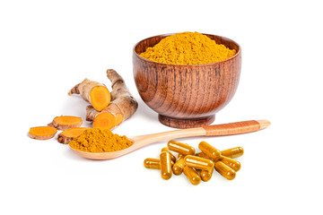 Dry Turmeric ( Curcuma longa linn) powder in wooden bowl with root sliced and capsules isolated on white background.