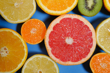 Fresh summer fruits on blue background. Healthy food concept. Flat lay. 