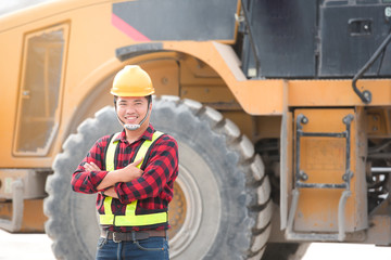 Workplace safety officers or civil engineers, teams with large vehicle backgrounds