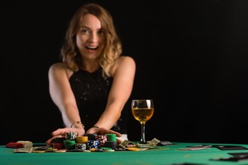 A girl raises bets with chips in a casino. Focus on chips, background for the gaming business.