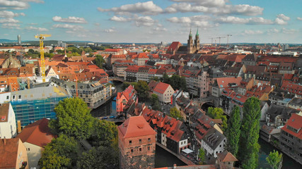 Naklejka na ściany i meble Nuremberg, Germany. Drone aerial view from a vantage viewpoint along city river