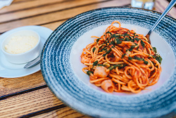 Pasta with seafood , parmesan and basil in a restaurant. Restaurant dish