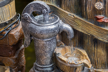 The decorative garden fountain looks like a Hand water pump