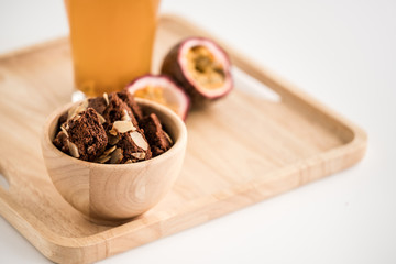 Glass of passion fruit tea, Refreshing summer drink and  dessert on wood plate and minimal style background.