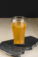 Glass of passion fruit tea, Refreshing summer drink and  dessert on marble plate and minimal style background.