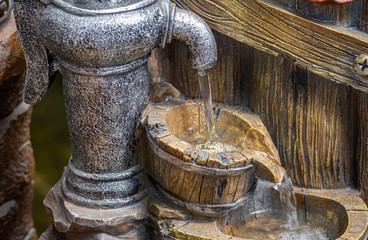 The decorative garden fountain looks like a Hand water pump