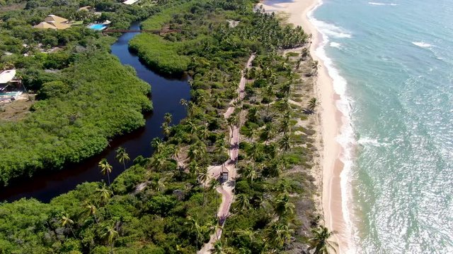 Aerial view of tropical white sand beach and turquoise sea water. Praia do Forte, Bahia, Brazil. Travel tropical destination