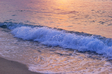 Evening sea waves on beach. Dusk sunlight on summer sea vacation.