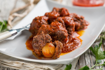 meatball with tomatoes sauce filled with potatoes