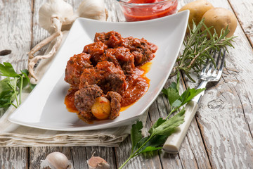 meatball with tomatoes sauce filled with potatoes