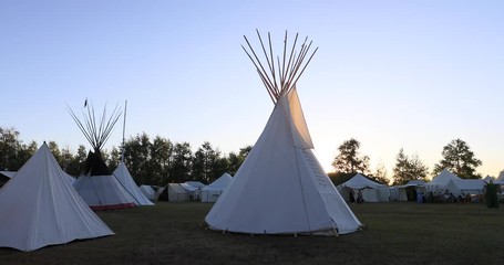 Rocky Mountain Man Rendezvous tents sunset camping. 19th century fur trading outpost on Oregon, California, and Mormon Trail. Pioneer, wilderness, camping and old trapper skills.