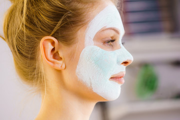 Girl with green mud mask on face