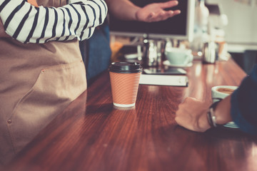 Coffee cup serving a client at the coffee shop.