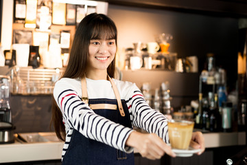 Young asian women barista smiling at coffee shop counter background, start up small business owner food and drink concept.