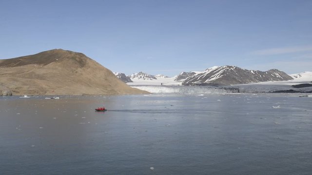 Boat (Zodiac) with tourists on Svalbard, Arctic - view from expedition vessel