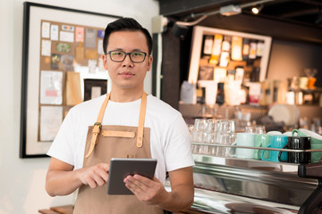 Fototapeta premium Young asian men barista get orders at the coffee shop,start up small business owner food and drink concept.