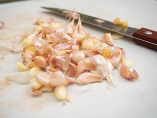 Peeled garlic on cutting board,Food,Raw material,Bad smell,Turned with a knife,Closeup,Cooking,tasty