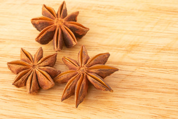 Star anise isolated on wooden background.