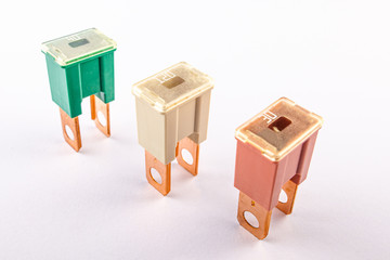 PAL blade normal profile Japan fuses with different ampers on isolated white backgrounds. Electric car parts.