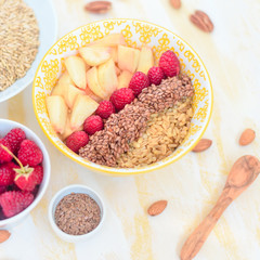 healthy breakfast oatmeal with fruits, raspberries, peach, flax seeds, nuts, good morning concept, healthy food, healthy breakfast