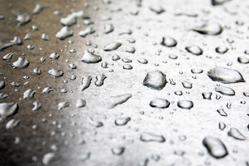 Water drops on shiny metal surface. Bad weather, wind and storm concept.